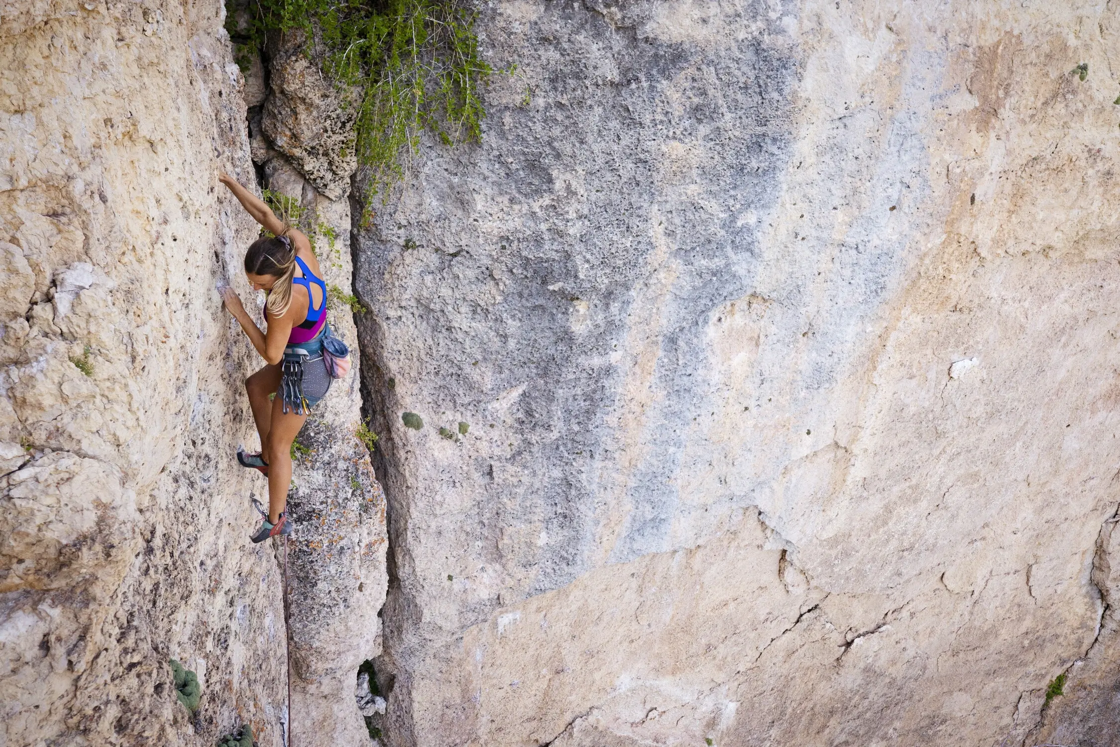 A female climber in a lightweight sport climbing harness