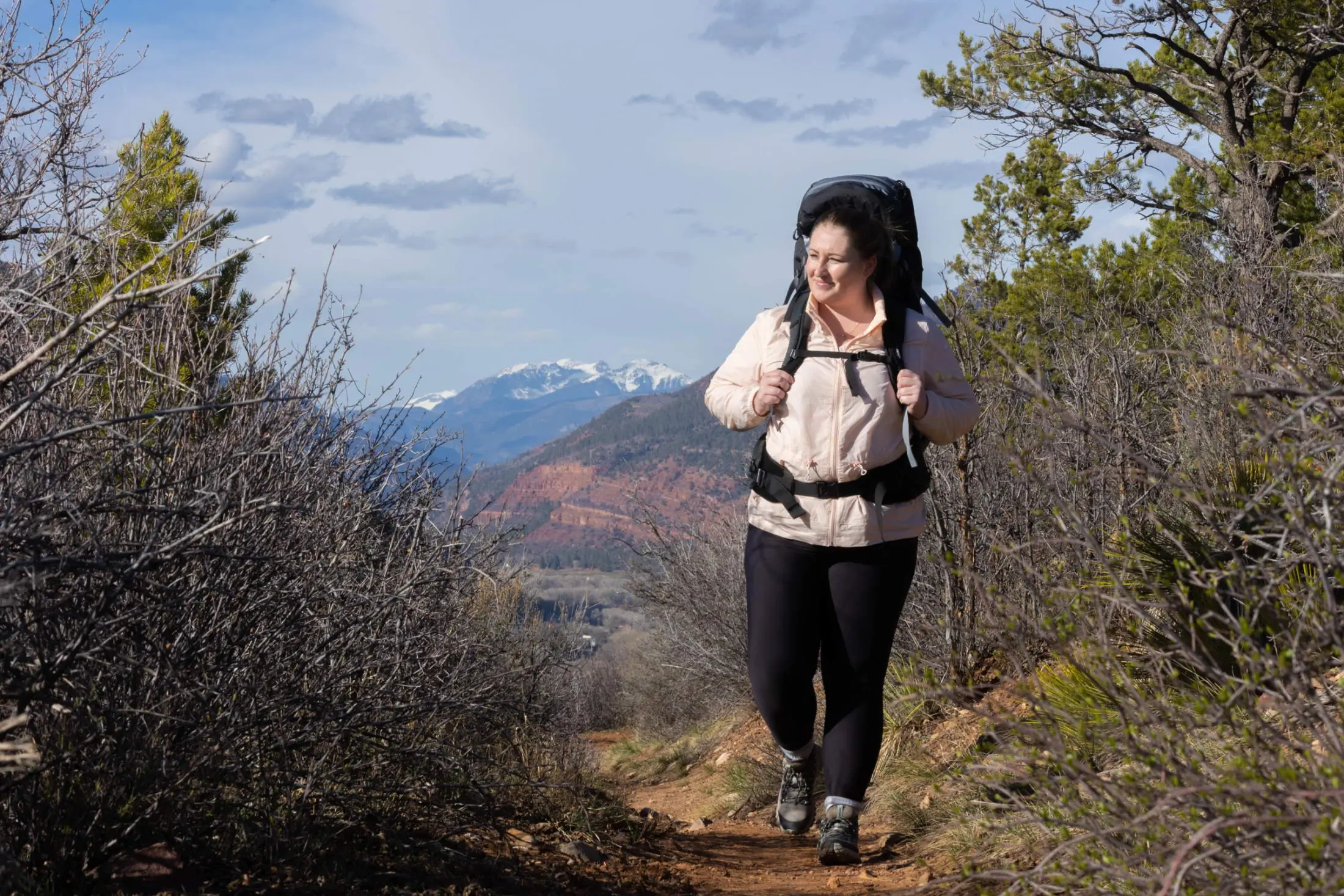Women hiking with extended fit osprey backpack