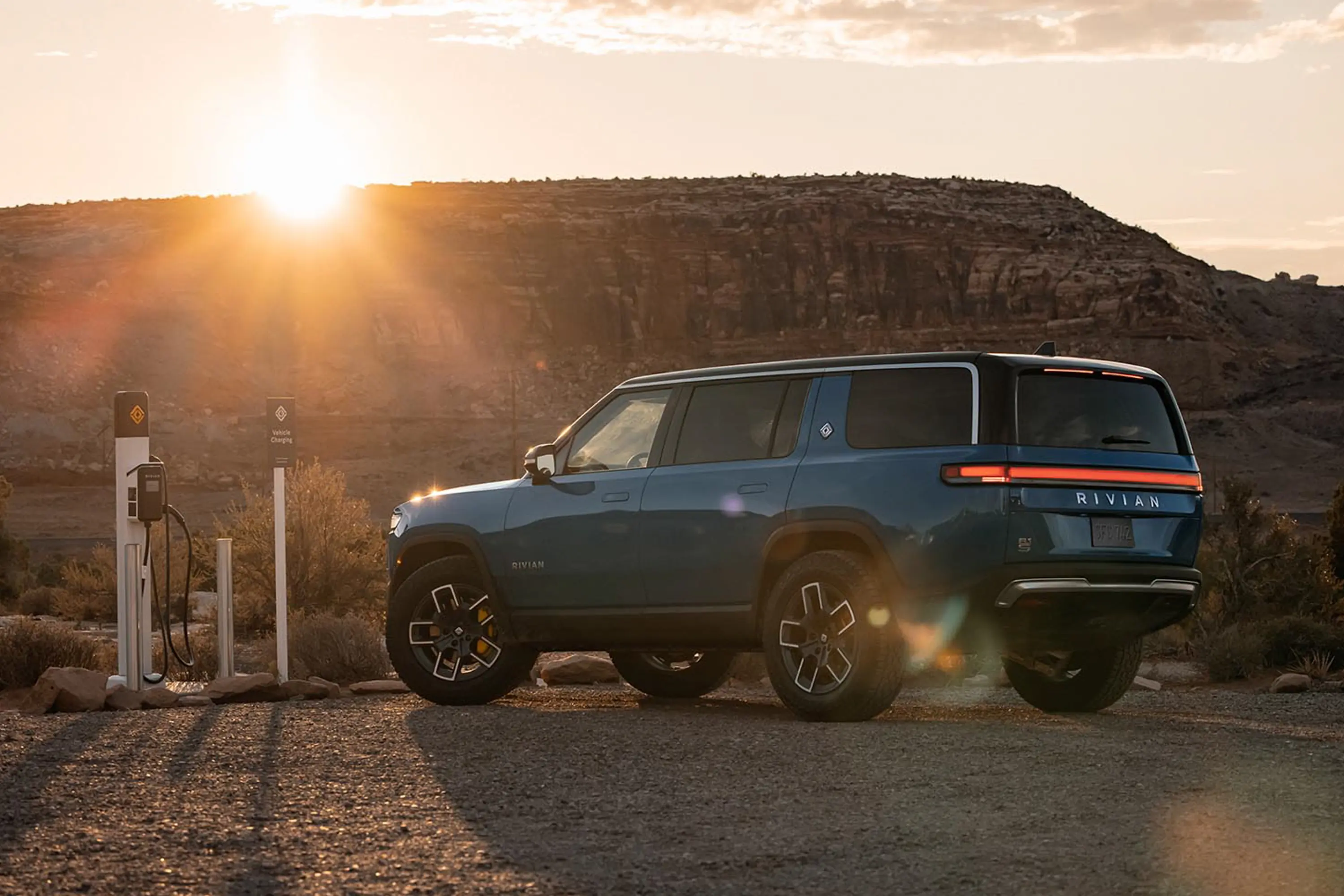 2023 Rivian R1S EV SUV review at charging station in desert rear three-quarter