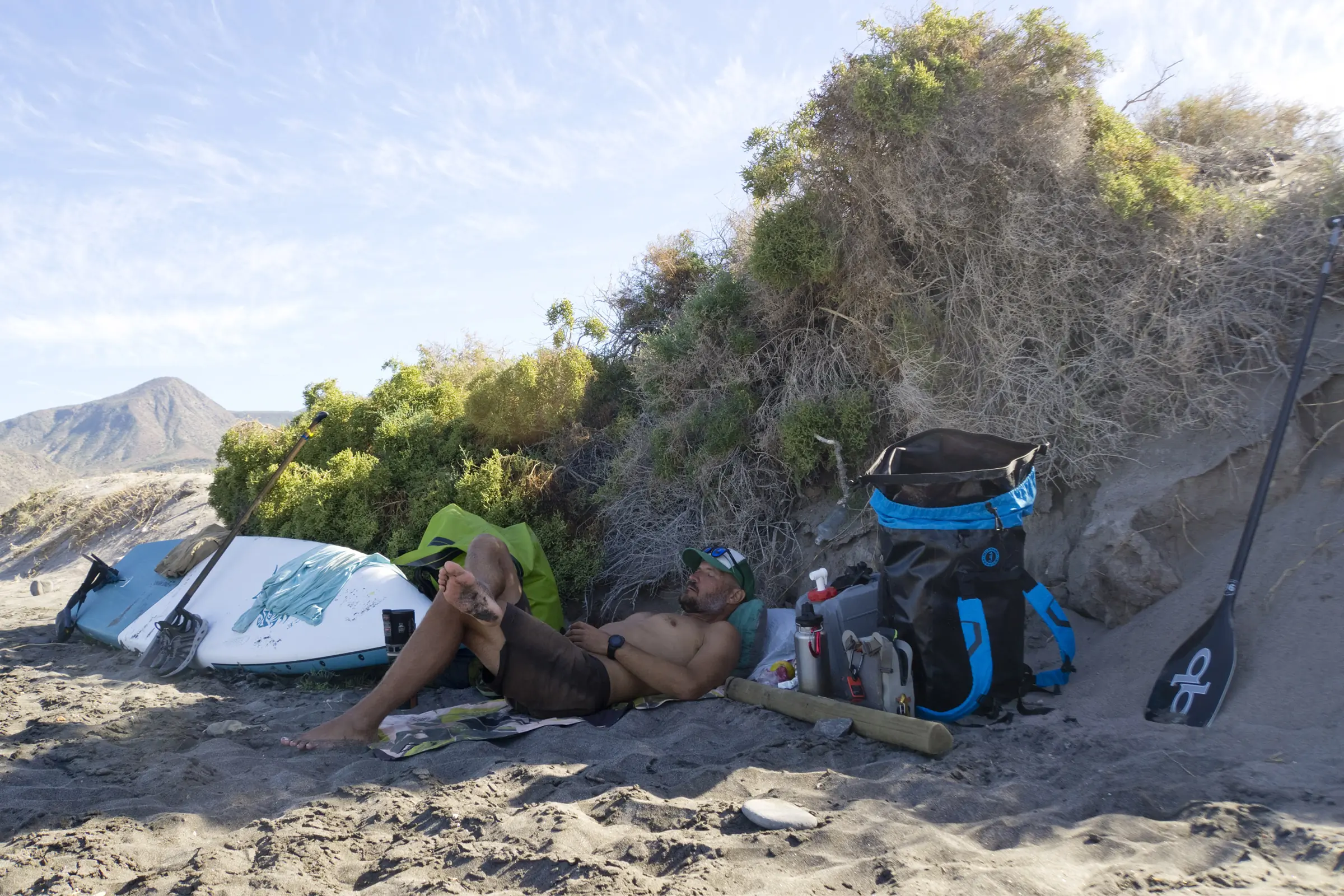 Mustang Survival Highwater 60L Waterproof Gear Hauler man on beach with gear