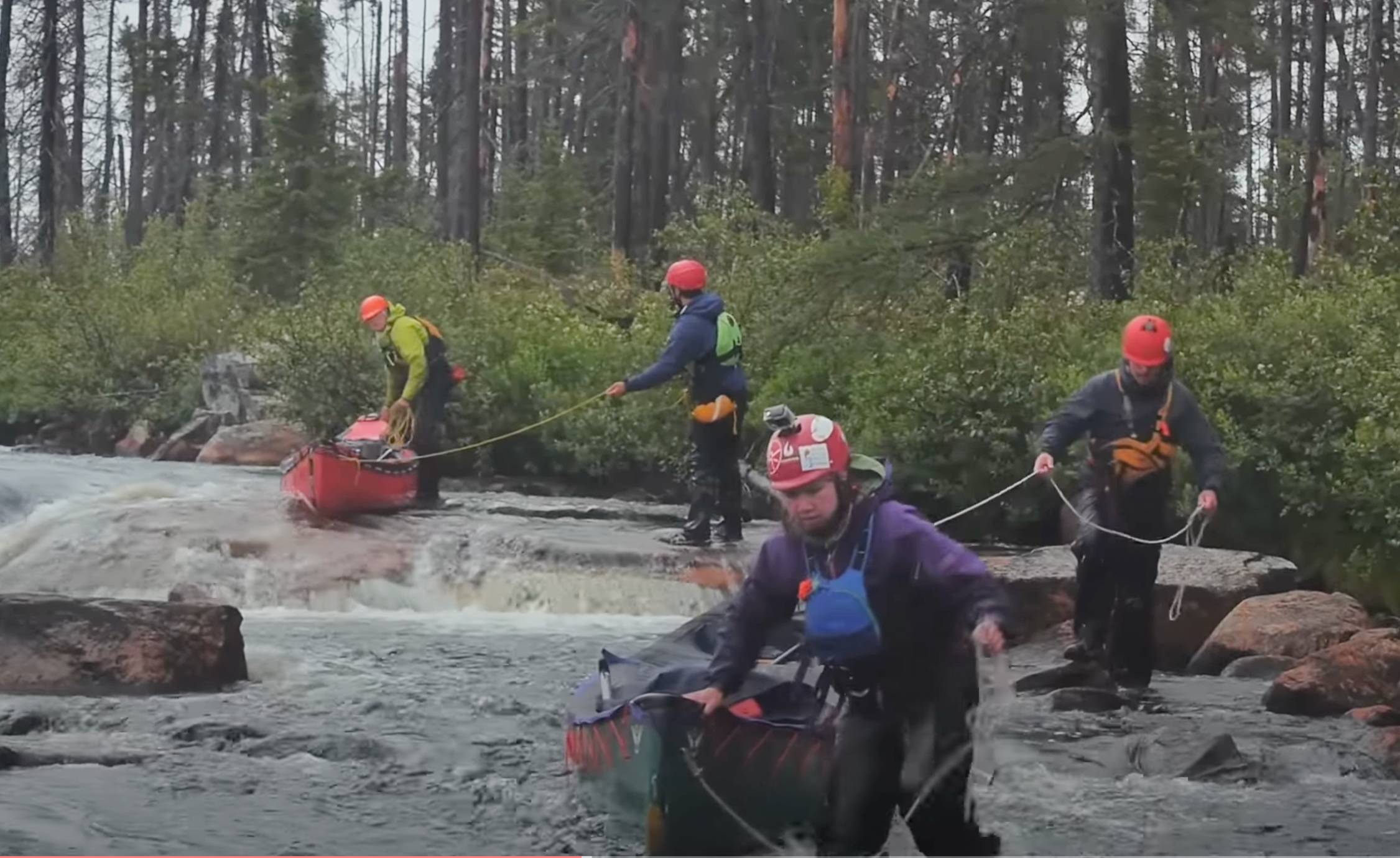 Backcountry canoers enter the water of Quebec’s Tichégami River