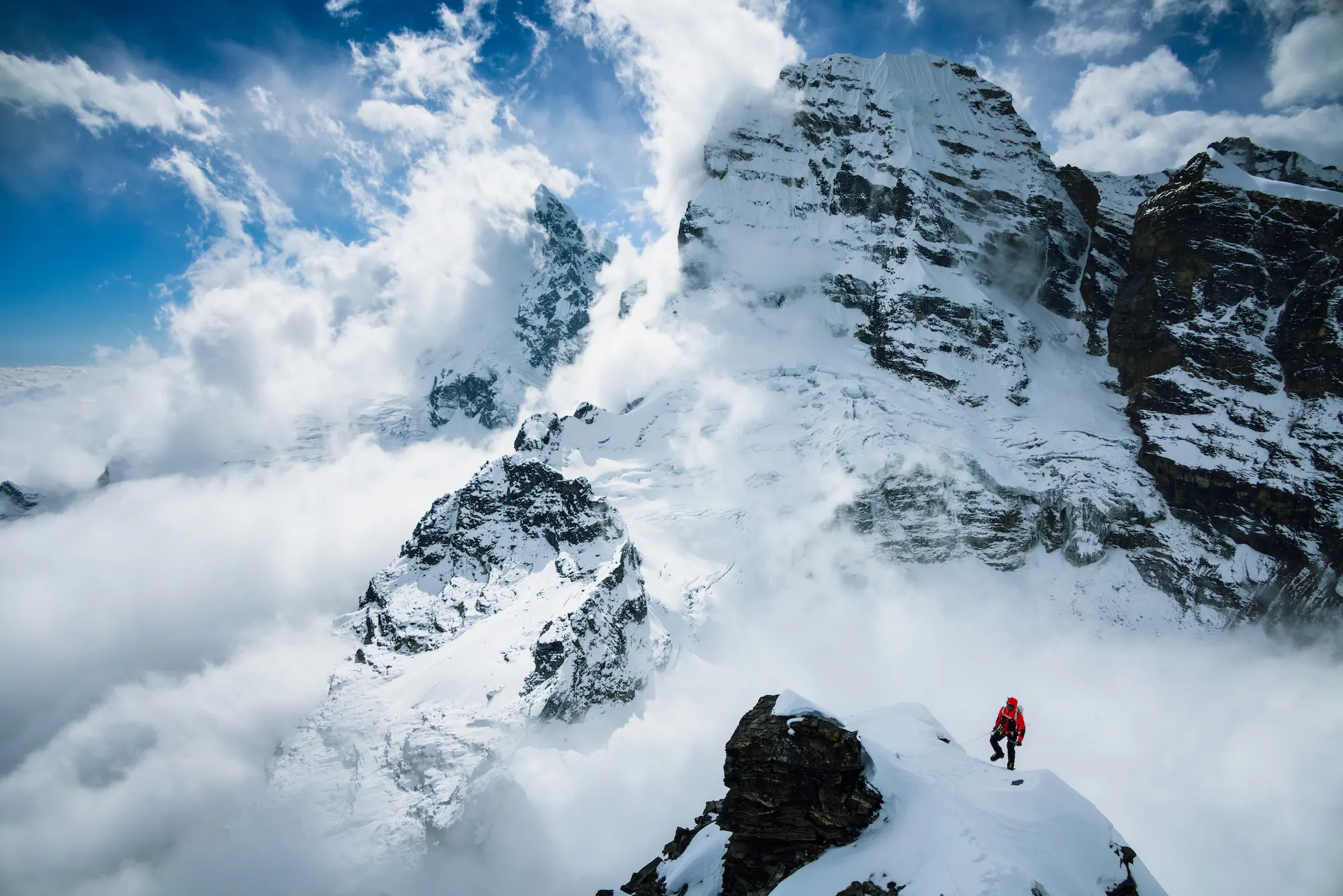 Madison Mountaineering Unclimbed Peaks Program in the Himalayas hiker on snow-topped peak