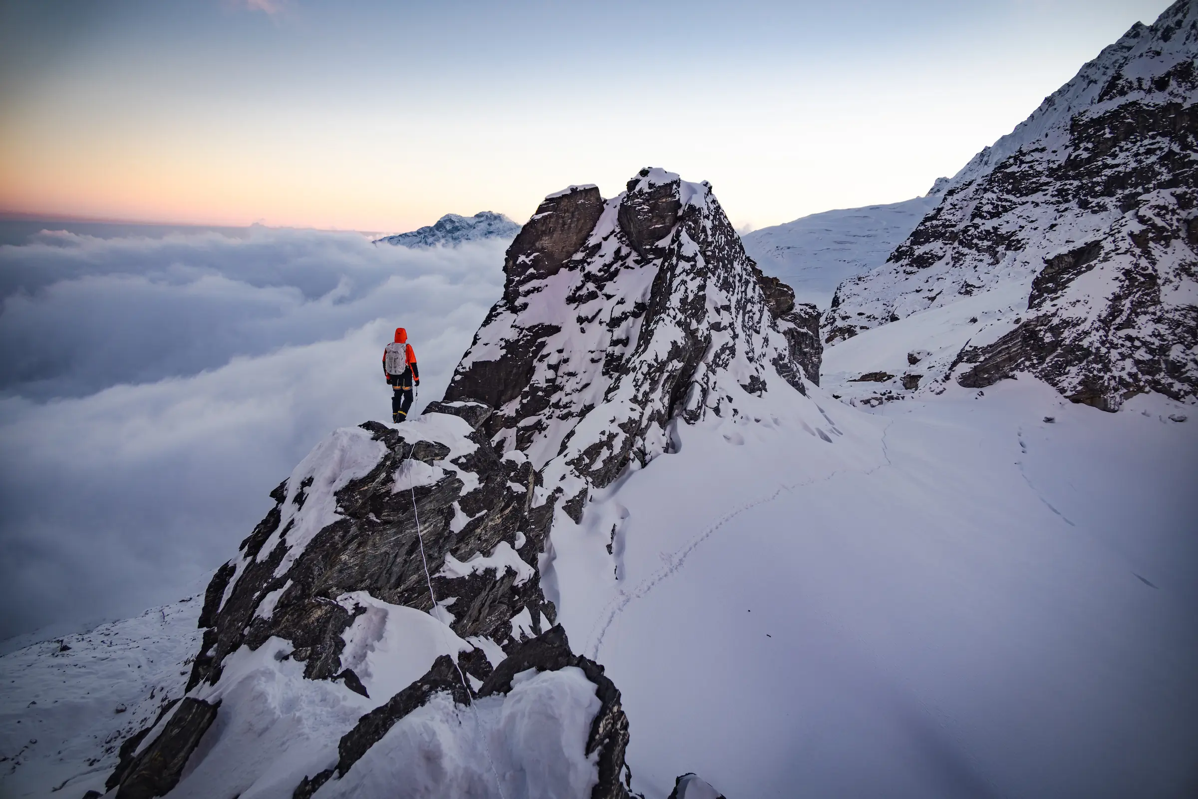 Madison Mountaineering Unclimbed Peaks program in the Himalayas hiker on snow-covered peak