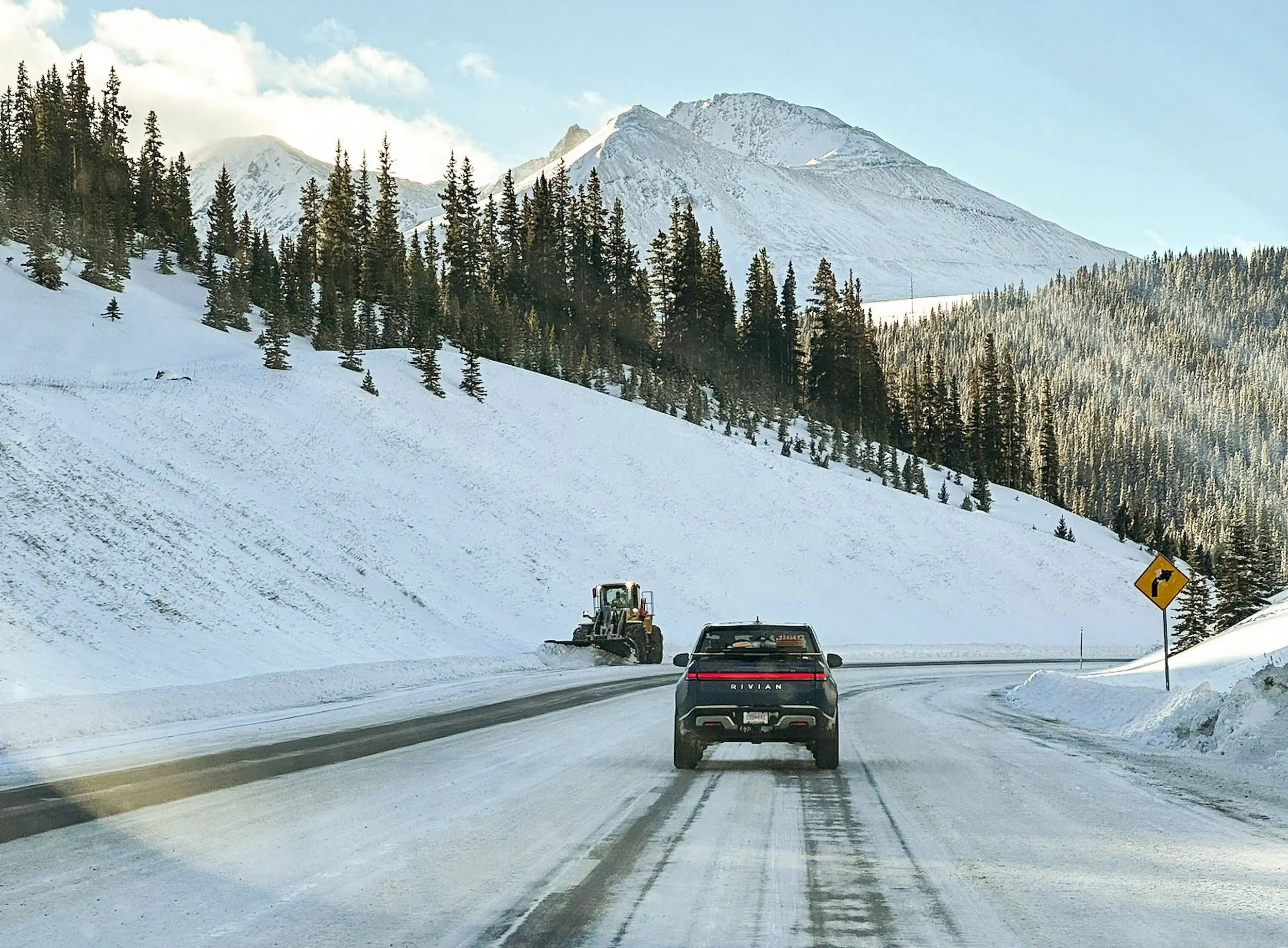 Rivian Snow Mode Rivian Snow Mode vehicle driving on plowed highway