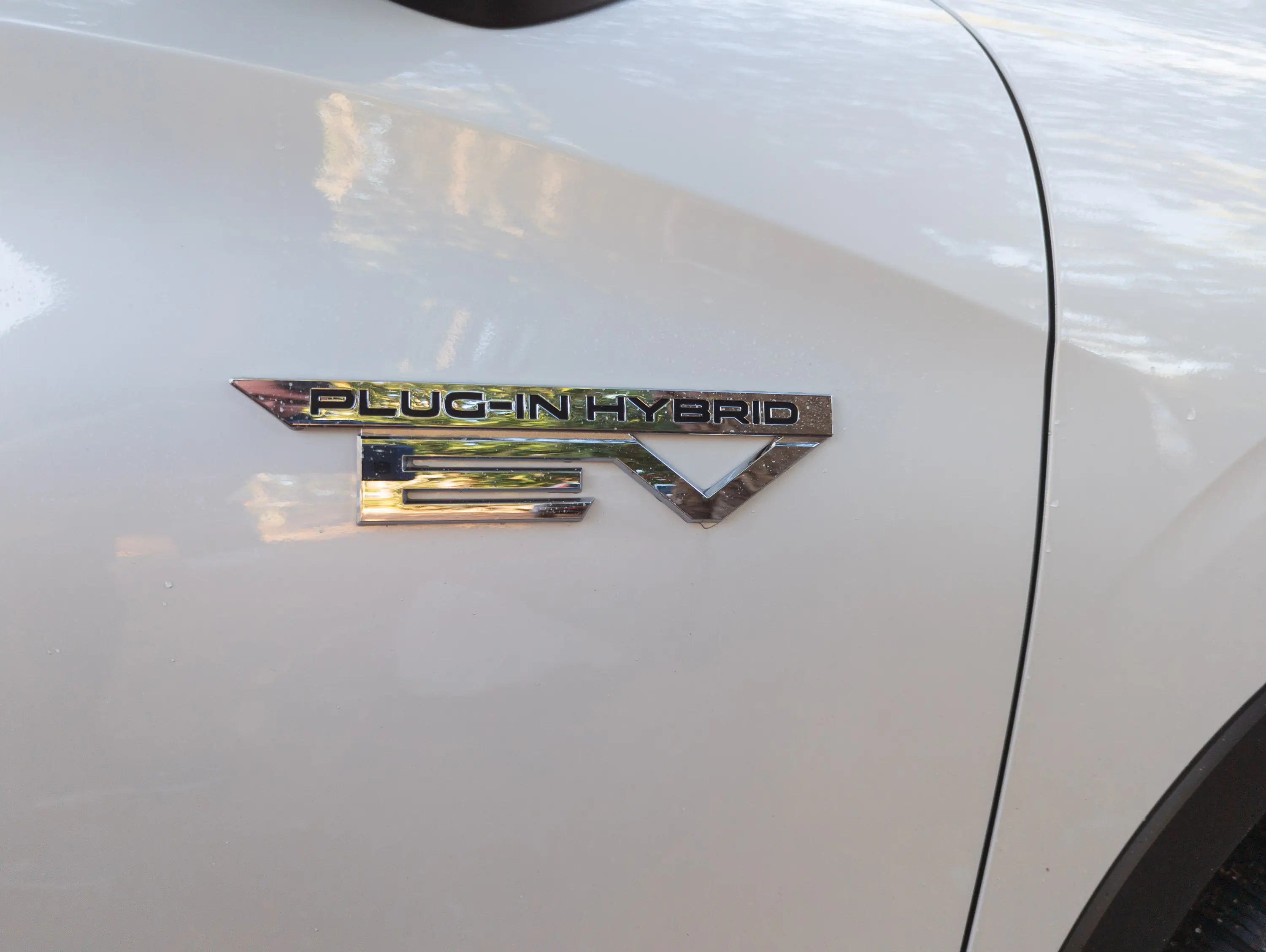 2023 Mitsubishi Outlander PHEV Review 2023 Mitsubishi Outlander PHEV Review close-up of plug-in hybrid EV badge