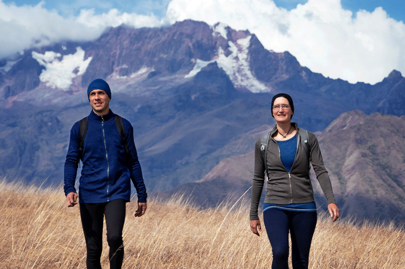 two people hiking in the mountains while wearing Arms of Andes alpaca wool clothing