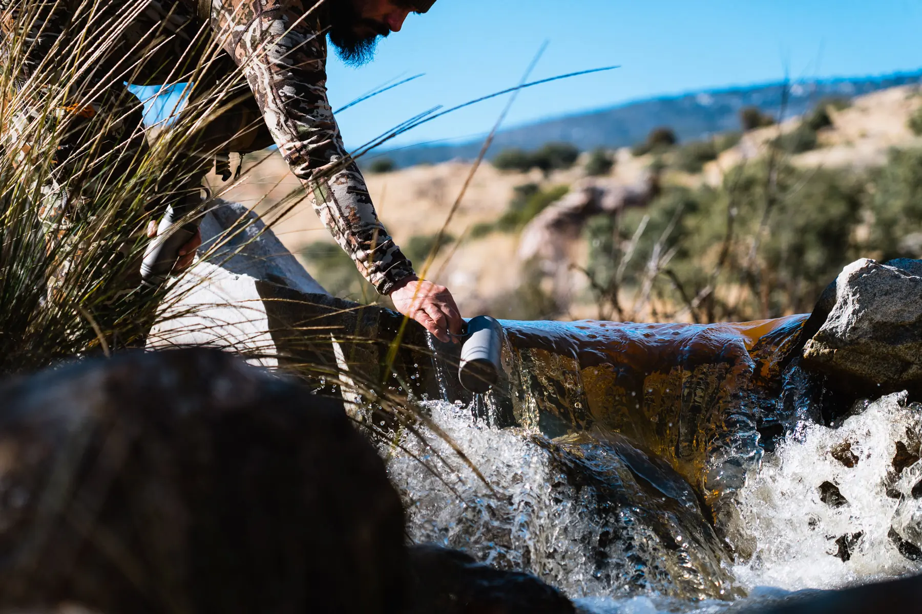 Scooping water with my Grayl Water Filter