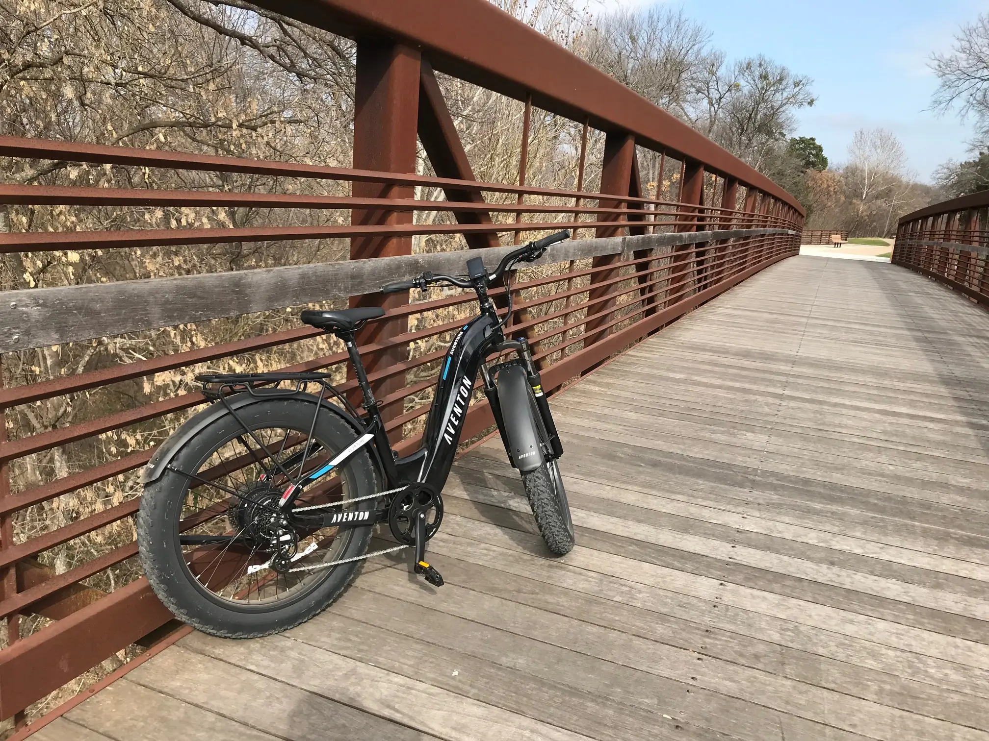 Aventon Aventure 2 e-bike on a wooden bridge.