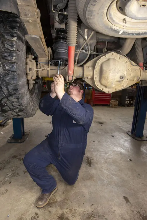 automotive tech installing Ram AirLift 5000 air spring assembly