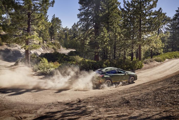 2024 Subaru Crosstrek on dirt road in forest