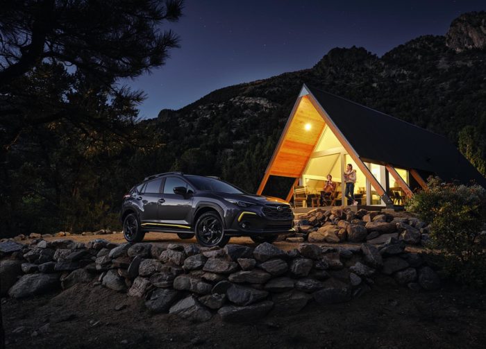 2024 Subaru Crosstrek in mountains parked outside a cabin