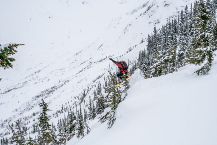 Skier launching into a pitch of mini pillows and poppers