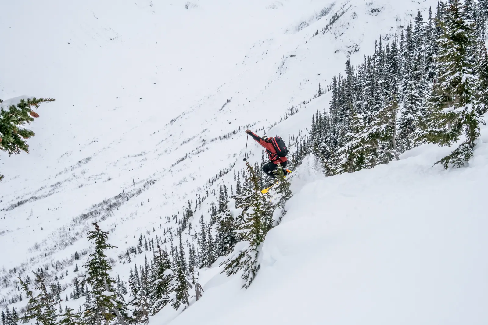 Skier launching into a pitch of mini pillows and poppers