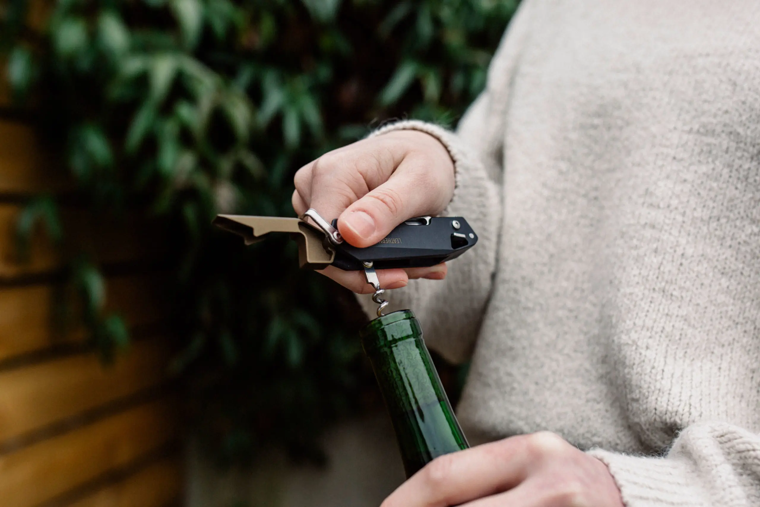 Leatherman multi-tool corkscrew opening a bottle of wine.