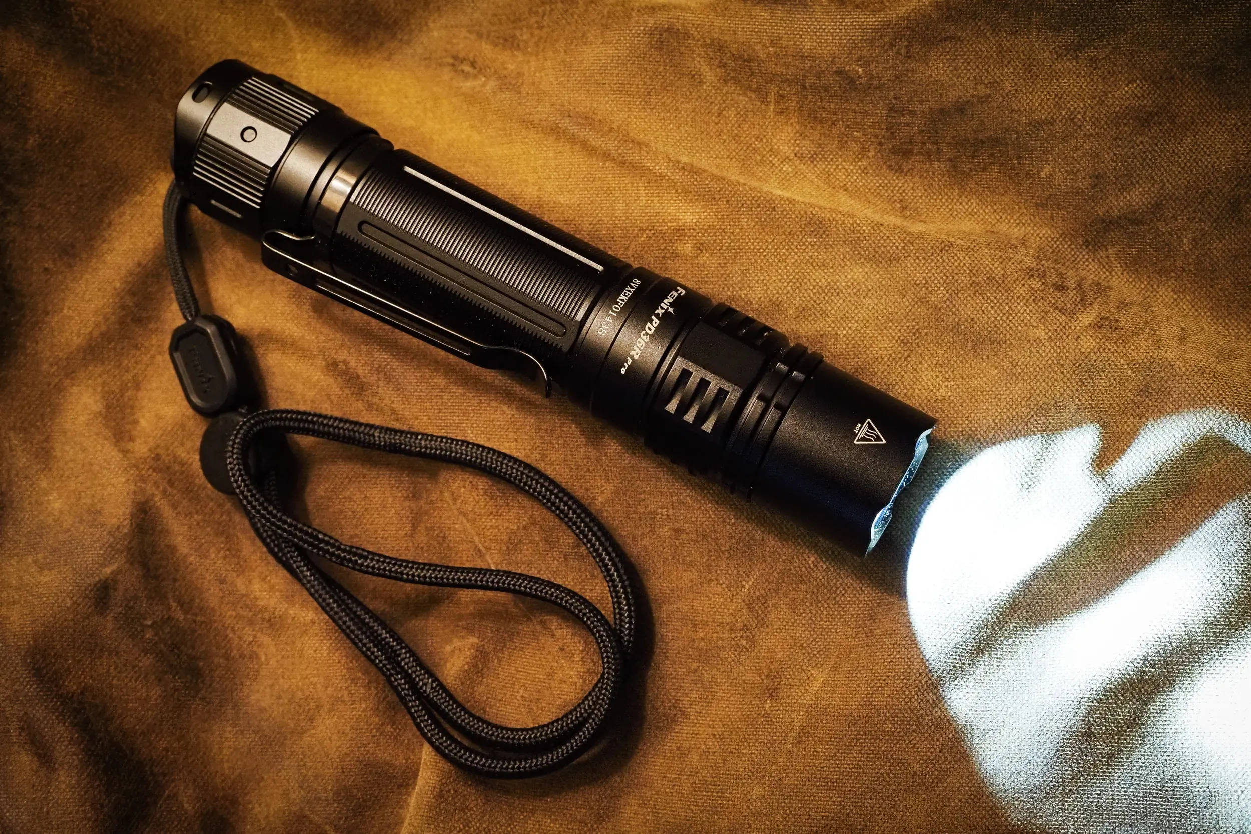 Fenix PD36R, best flashlight turned resting on fabric