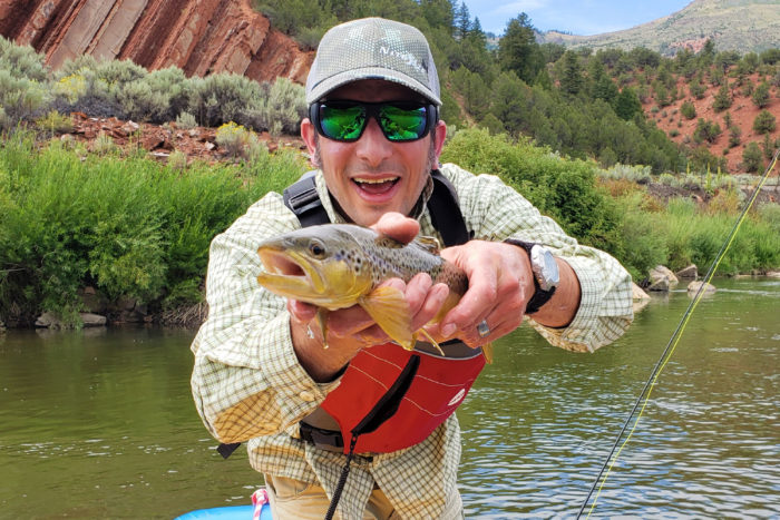 Jay Getzel holding a trout and fly fishing
