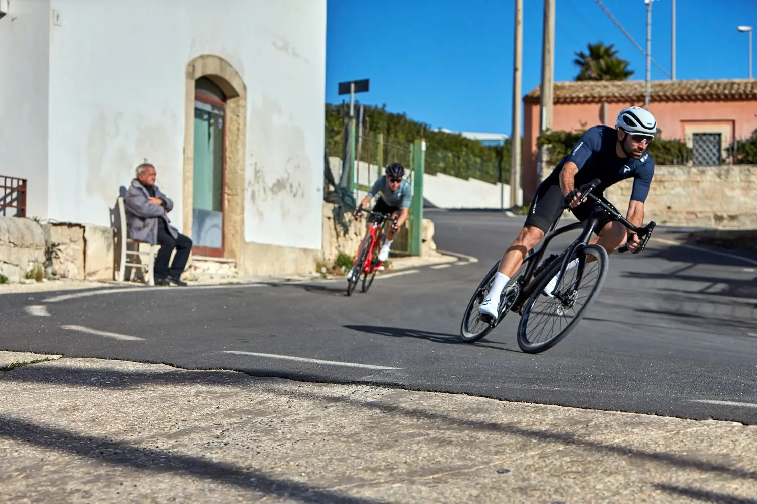 Riders on Pinarello X endurance bikes with a man watching