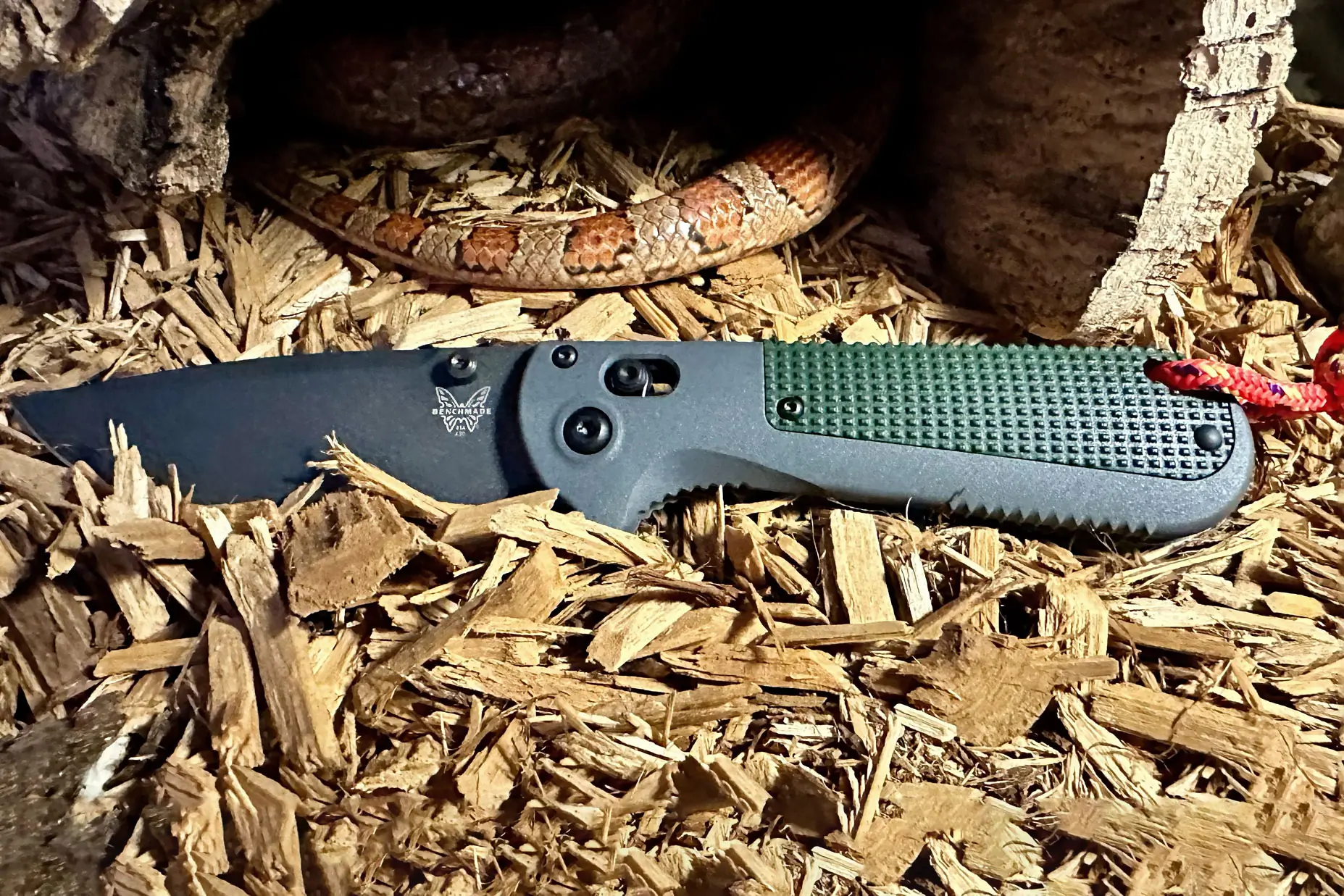 Benchmade Redoubt knife next to a snake