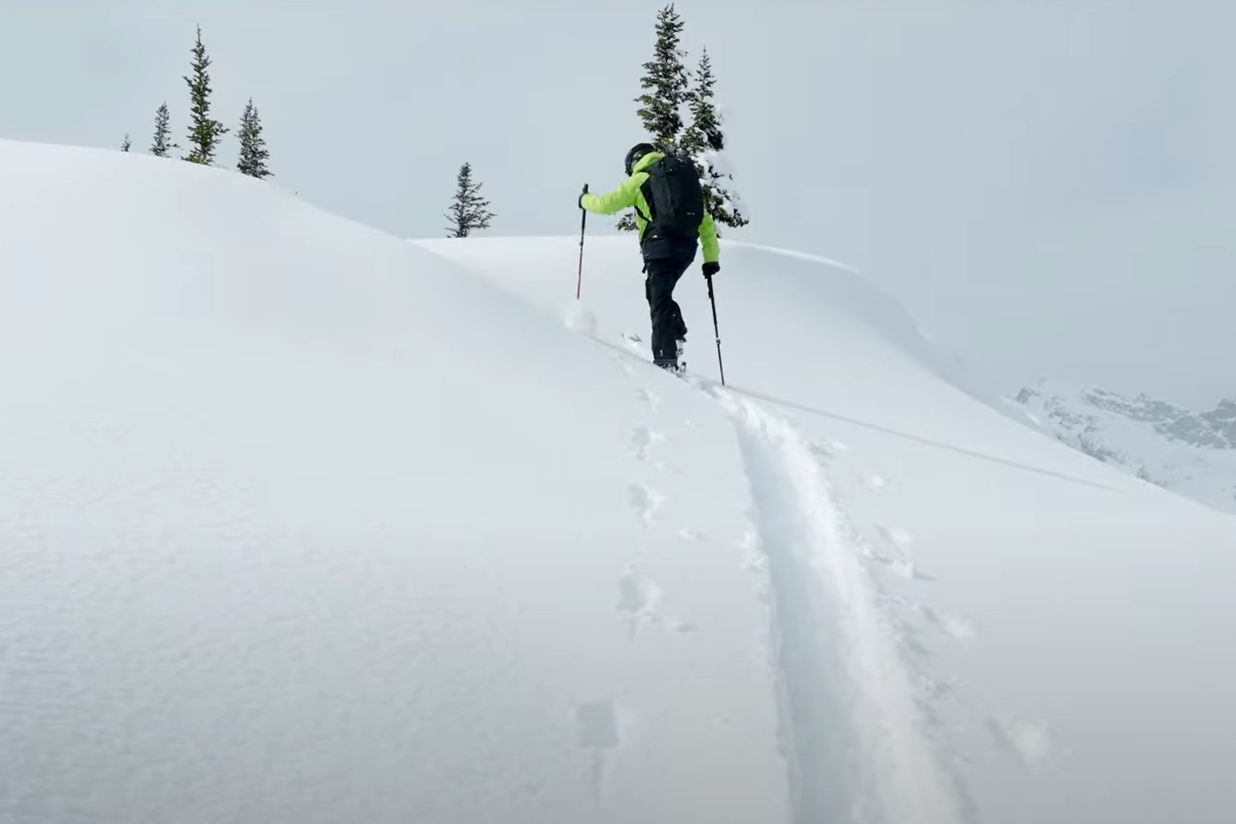 A man skinning up a slope