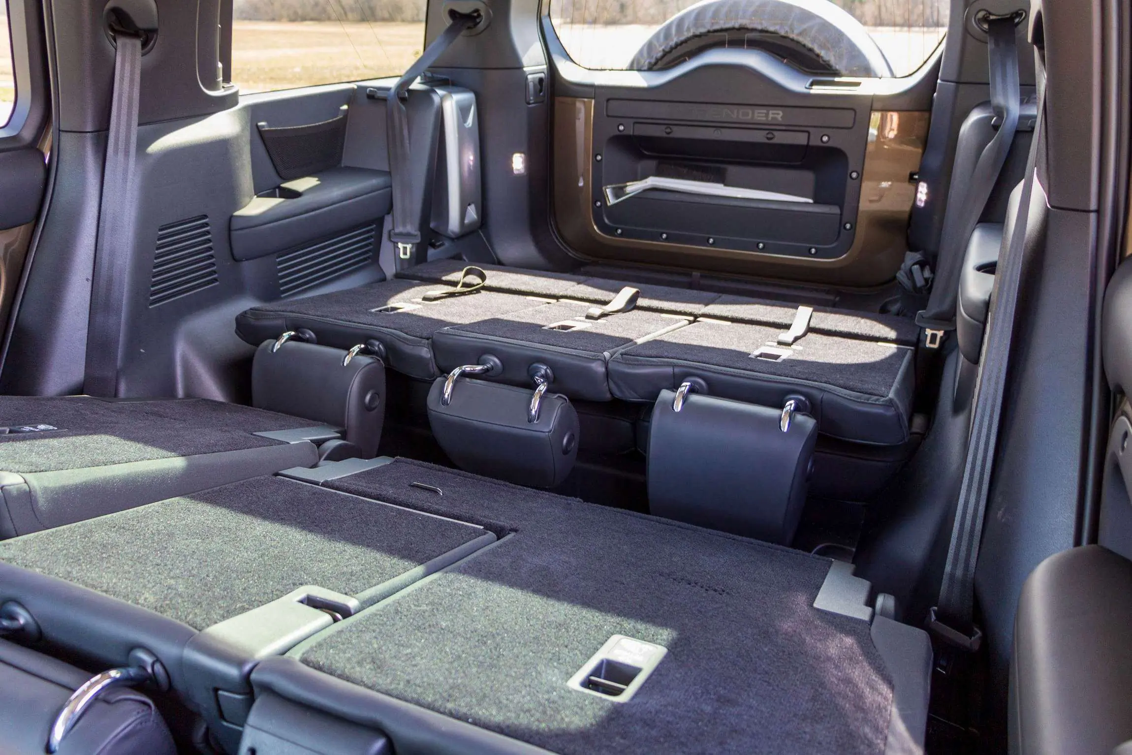 Land Rover Defender 130 Review interior second and third row seats folded.