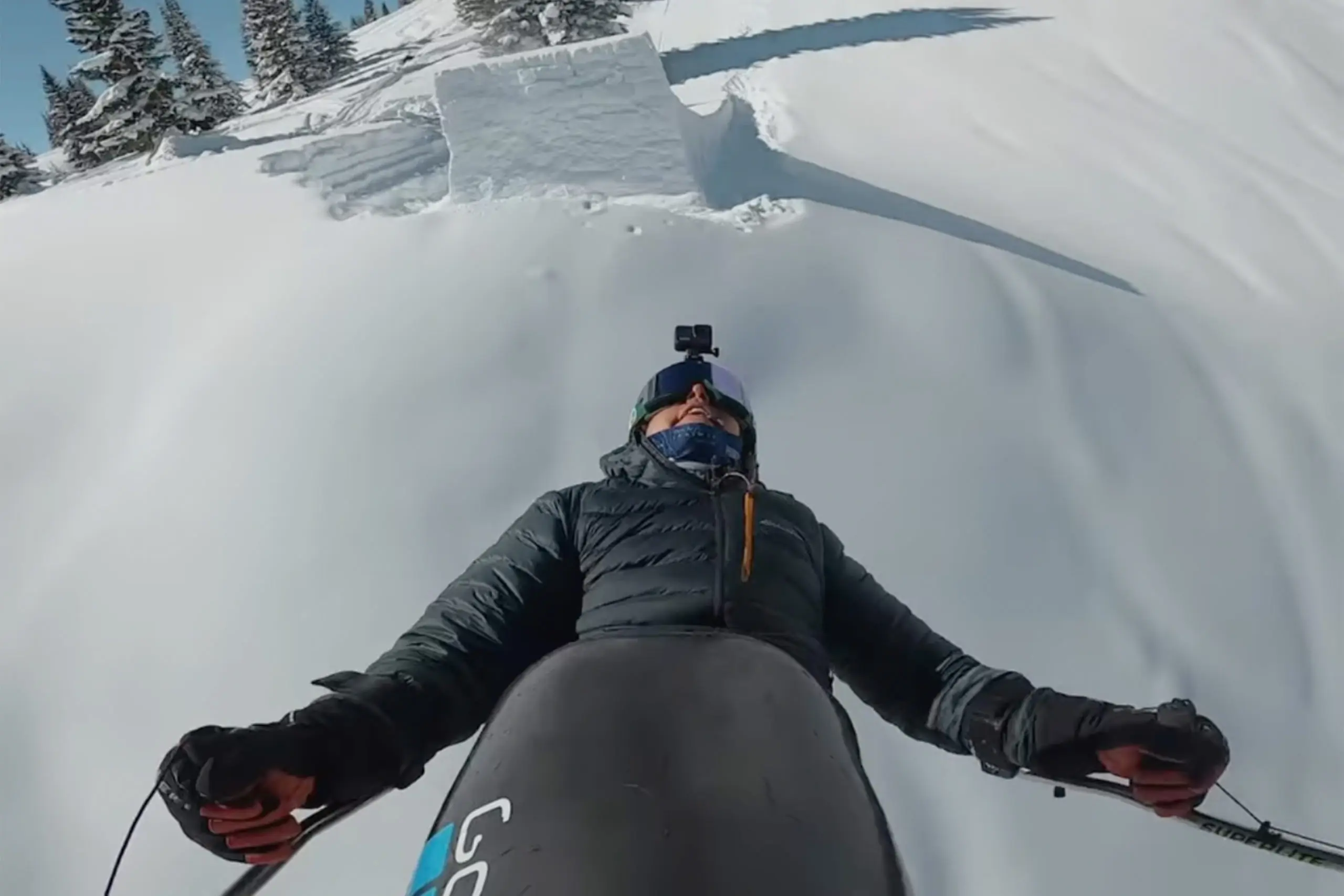 trevor kennison mid-air as he completes a full double backlip on a sit-ski