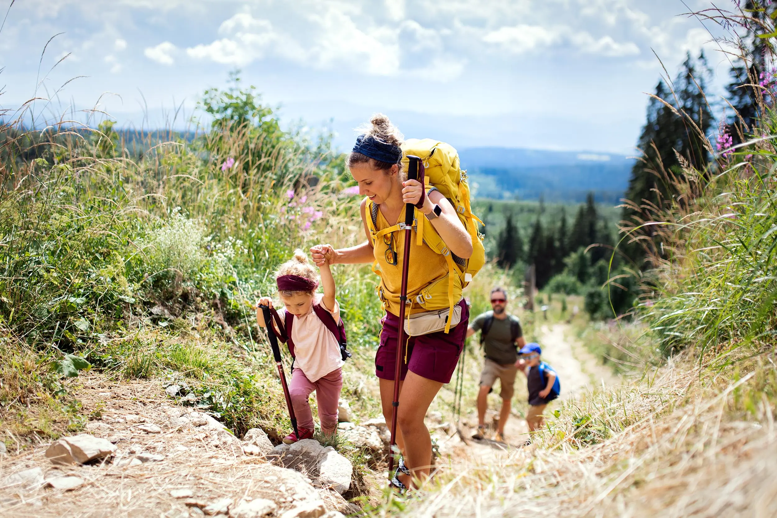 A family hiking up a trail