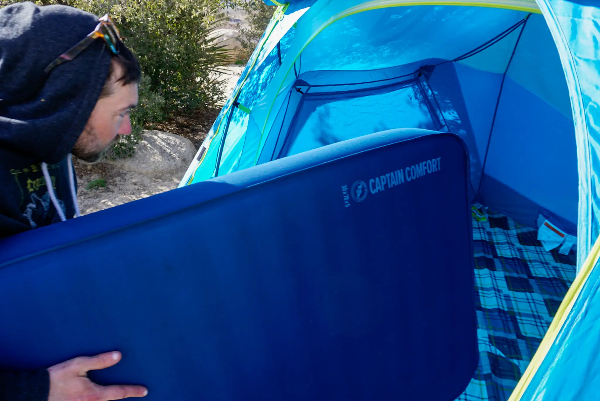 Camper Placing Big Agnes Capitan Comfort Sleeping Pad Into Tent