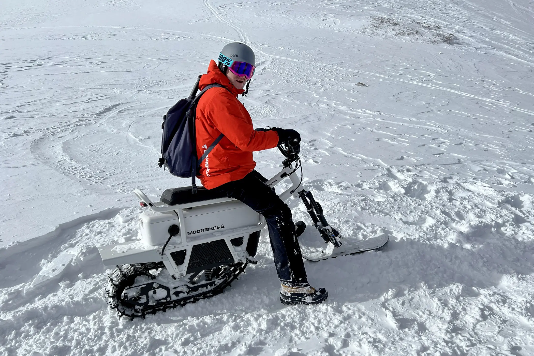 MoonBike Electric Snowbike with rider in snow.