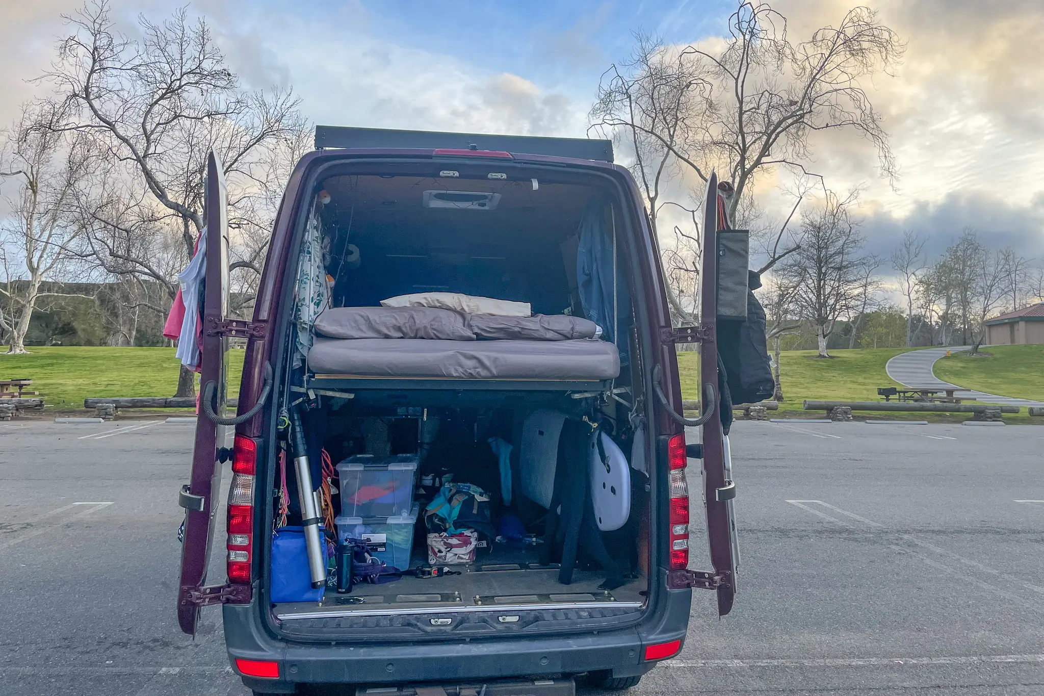 Vanlife camper in parking lot with rear doors open
