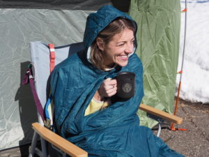 Former GearJunkie employee Katie Jedlicka Sieve enjoying a cup of coffee from her REI camp mug in her REI Wonderland chair.