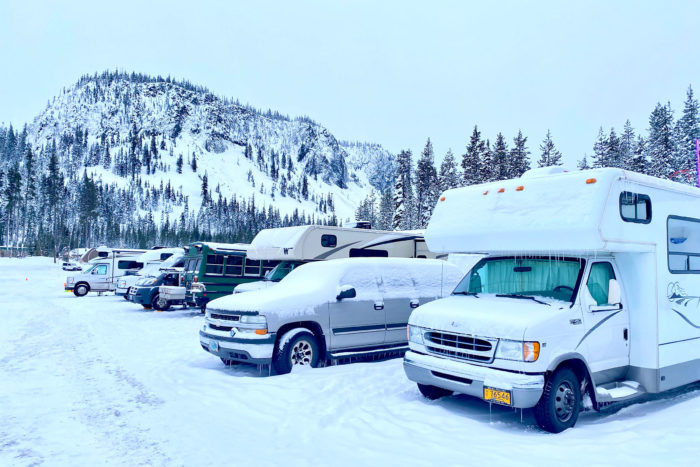 RVs and campers parked at a ski resort parking lot
