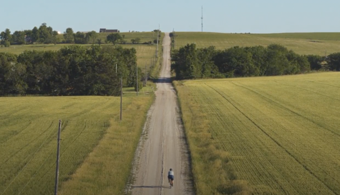 Marley Blonsky rides on a long dirt road