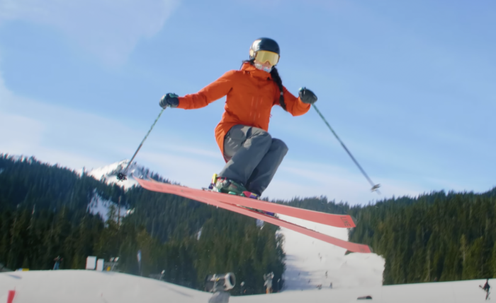 a woman makes a ski jump