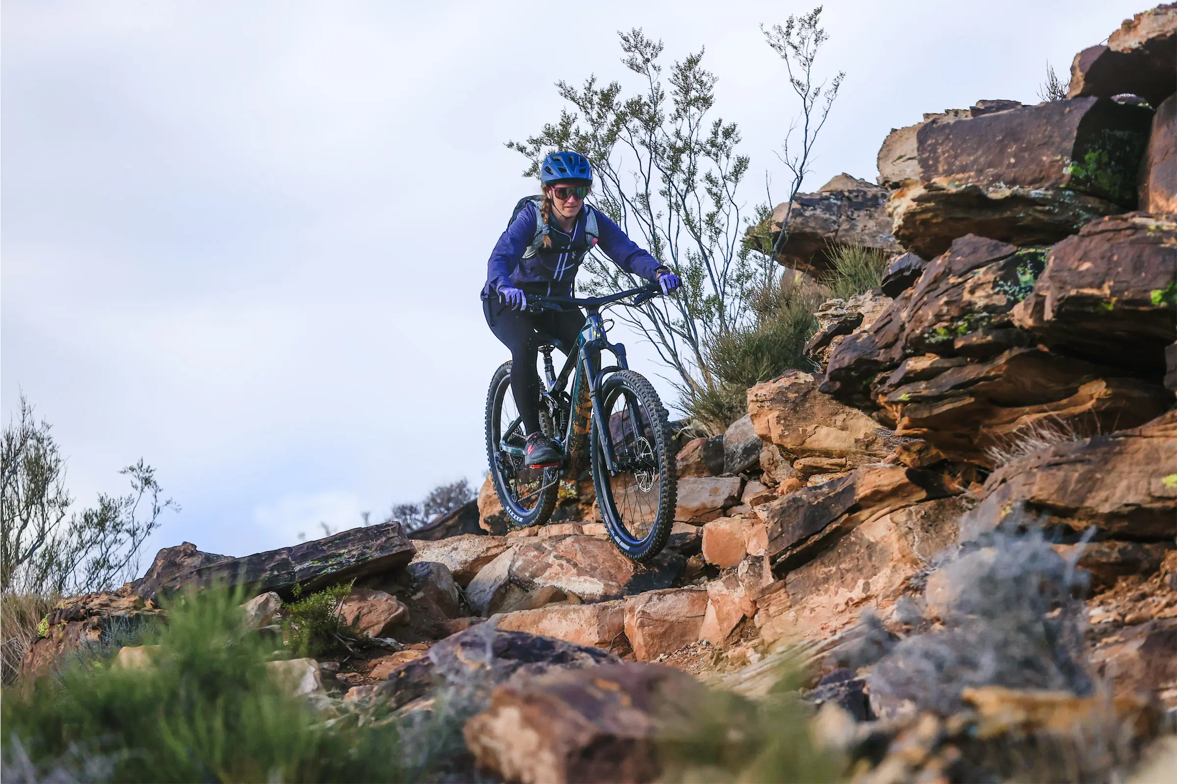Liv Intrigue X Advanced E+ Elite 1 E-MTB Review rider on bike over rocks