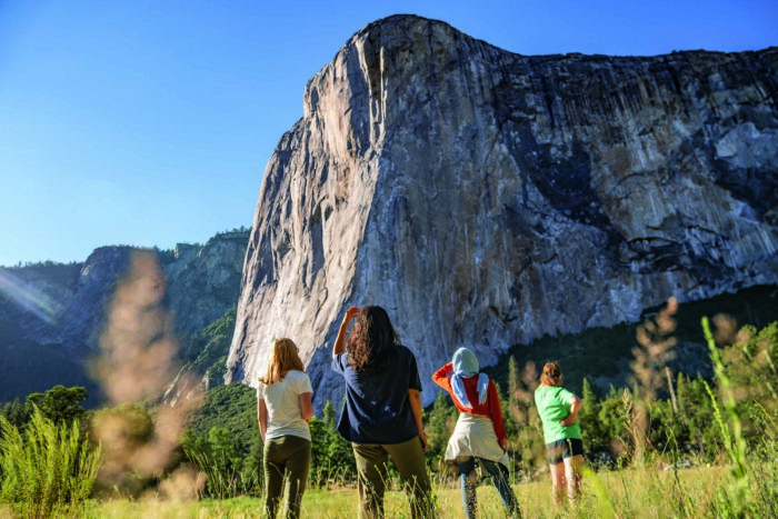 four woman look at a rock face in the Yosemite valley