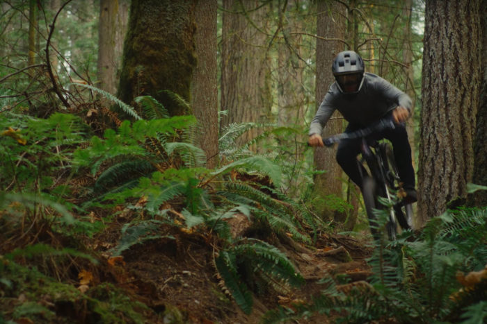 a man rides a mountain bike down a trail in british columbia