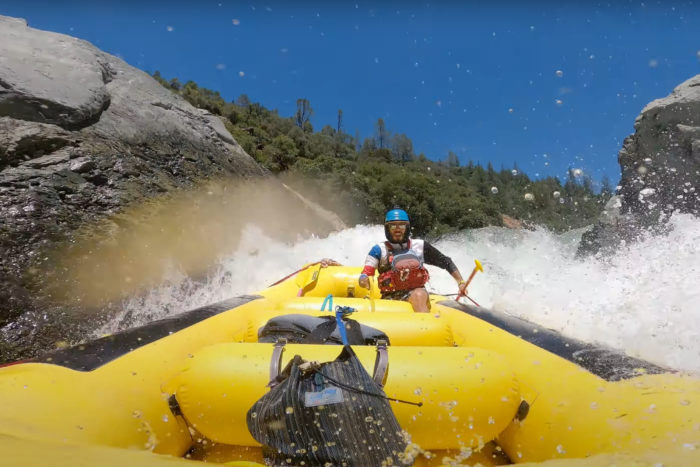 A whitewater guide runs a rapid