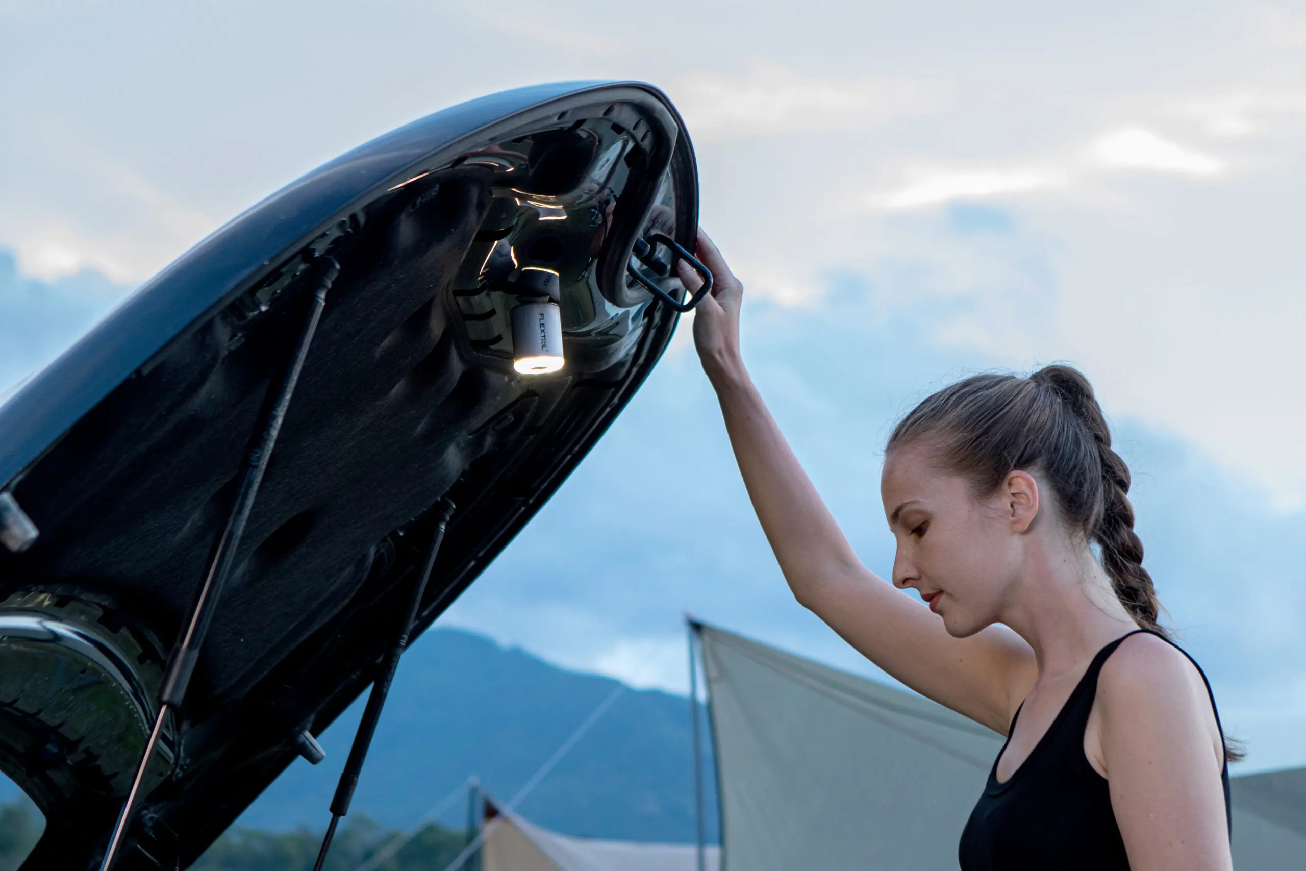 FLEXTAIL's TINY PUMP 2X using it's magnetic power to illuminate under the hood of a car for someone looking under the hood.