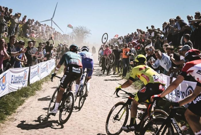 Cyclists turn onto a cobblestone section of Paris-Roubaix.
