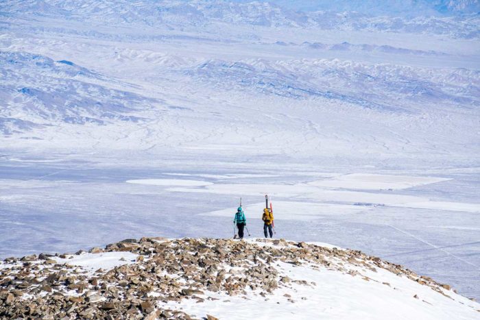 Two skiers on a snowy mountain above Great Basin National Park