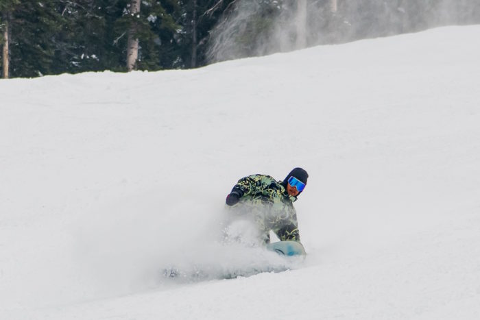 Young man snowboarding