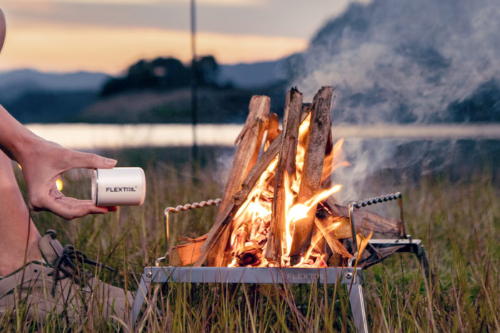 The FLEXTAIL TINY PUMP 2X blowing air into a fire to help stoke it.