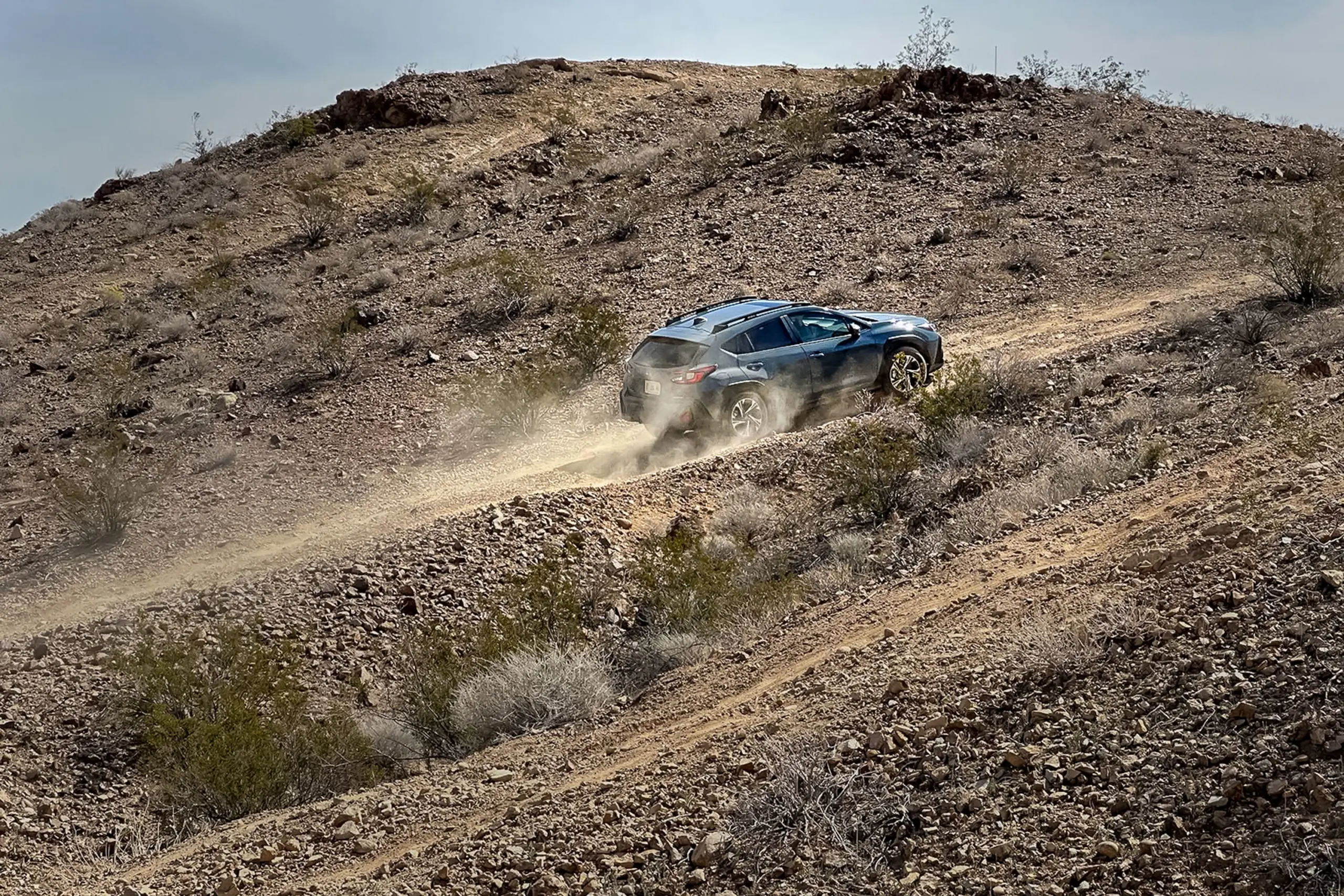 2024 Subaru Crosstrek Review driving up off-road trail hillside
