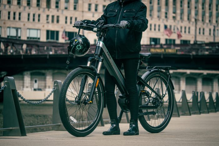 woman standing over a step-through e-bike
