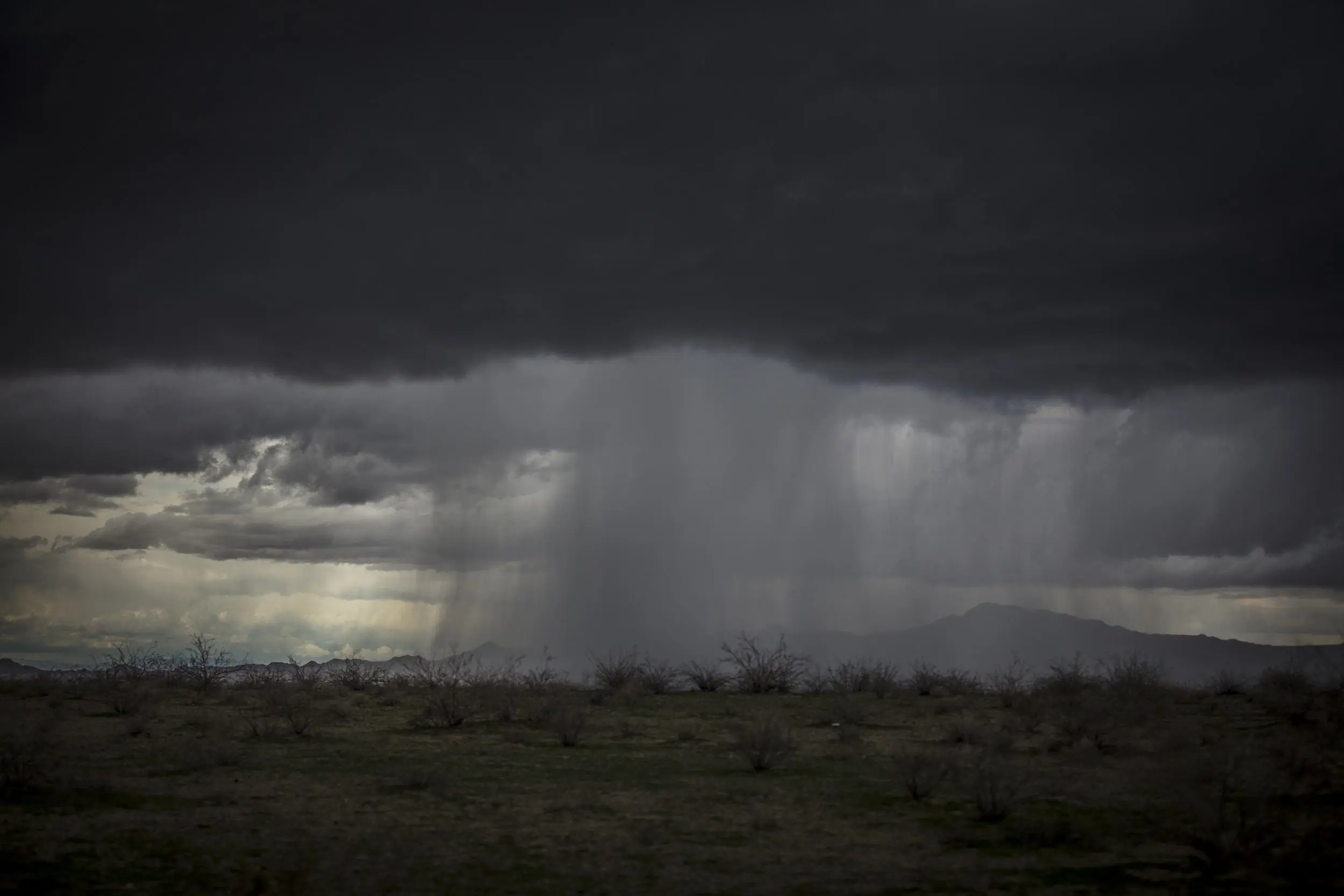 storm clouds dropping heavy rain on the Mojave Desert