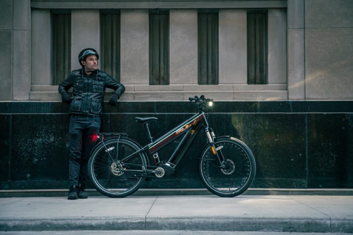 man standing next to an e-bike