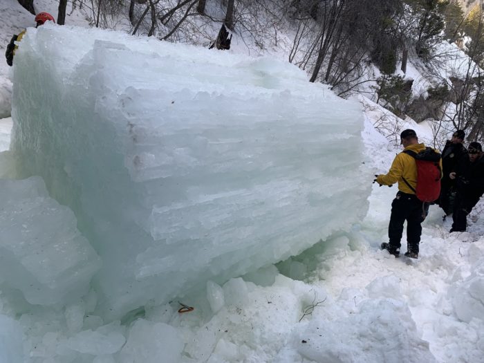 a huge column of fallen ice with a carabiner visible under one corner