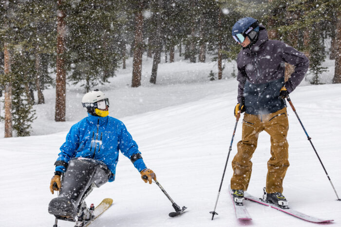 author aaron bible skis with sit-skier trevor kennison in Winter Park, colo.