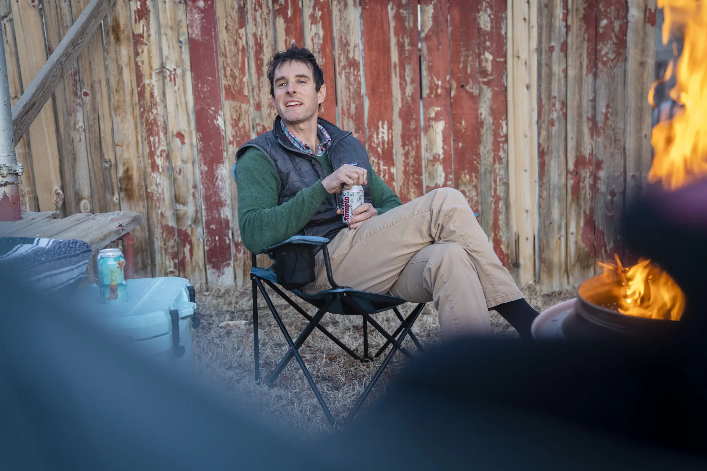 A Man Sits in the REI Co-op Skyward Chair Enjoying a Tasty Beverage