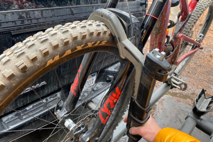 Clemping down on the front wheel with the hook on the Thule T2 Pro XTR bike rack
